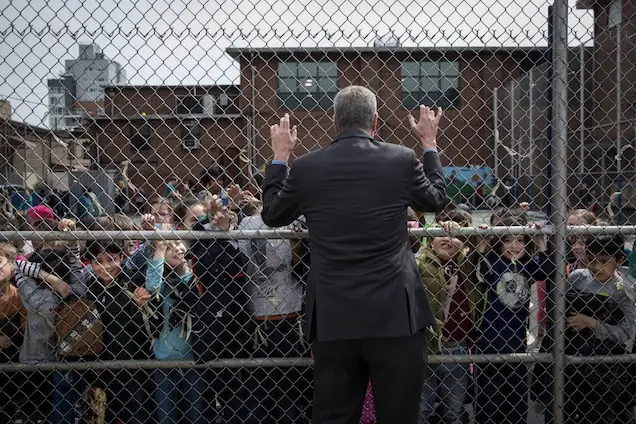 Mayor Bill de Blasio says hello to students during recess at P.S. 372